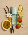 Kitsch product with vanilla beans, lemon slices, strawberries, and a flower on a beige background