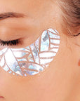 Woman wearing silver leaf-shaped eye patches on her face