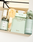 The GREEN GODDESS gift box in creme, including DETOX bath salts, large candle, dry brush, collagen face mask, hand cream, scalp scrubber, silk scrunchie and hair towel.