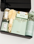 The GREEN GODDESS gift box in black, including DETOX bath salts, large candle, dry brush, collagen face mask, hand cream, scalp scrubber, silk scrunchie and hair towel.