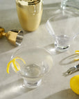 Heavy Base Crystal Martini Glasses next to shaker, jigger, peeler and lemon twist