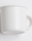 White ceramic pitcher on a light gray background