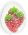 Red and green gummy candies on a white plate