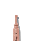 Rose oil dropper bottle on a white background