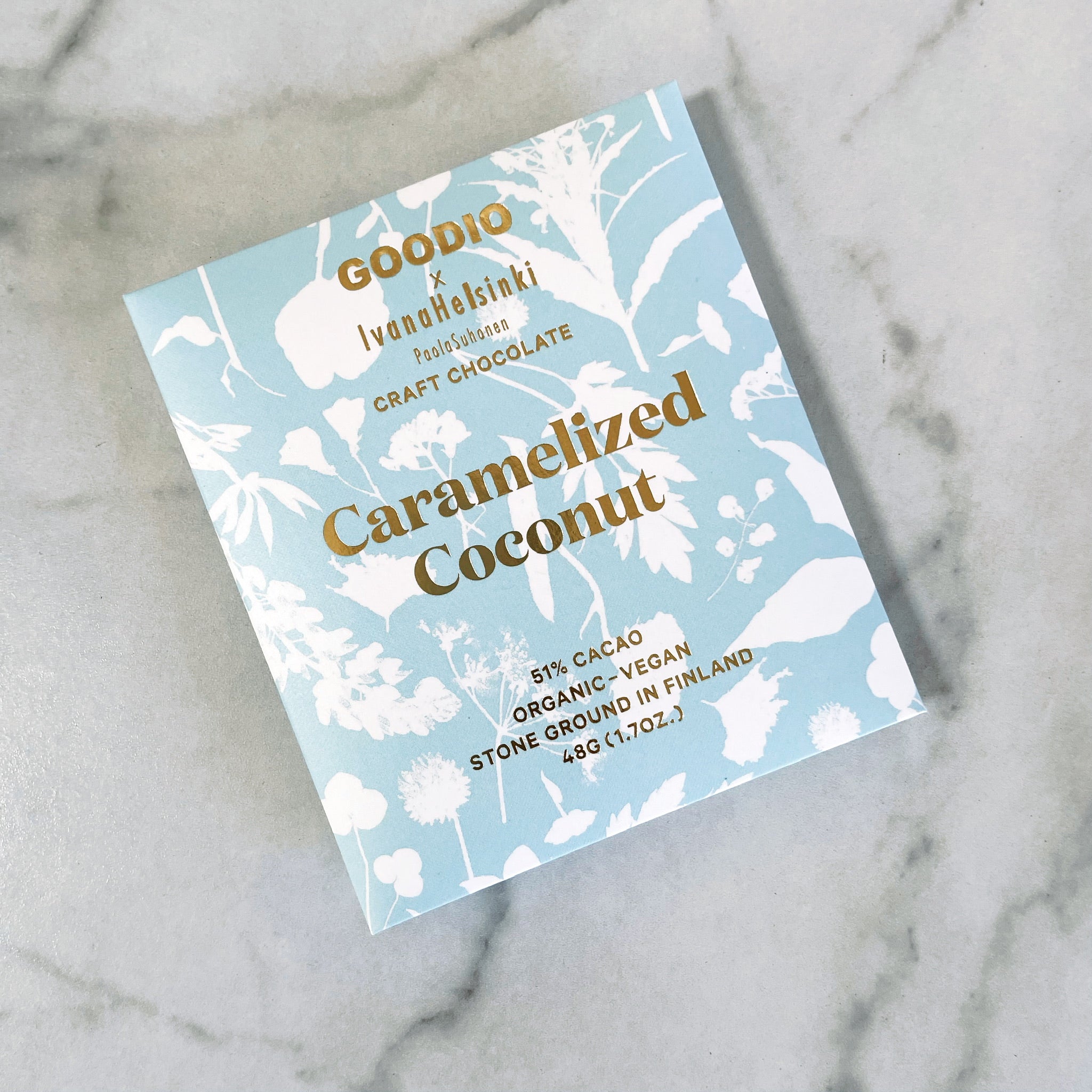 Goodio's Caramelized Coconut chocolate bar with a white and blue floral packing.