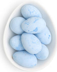 Small dish full of blue egg-shaped candies.