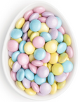 pink, purple, blue, and yellow coated chocolate pieces in white oval dish