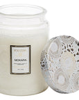 large glass candle with sunflowers imprinted on the glass. Mokara Voluspa label