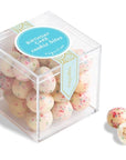 Clear plastic cube with pink and blue speckled birthday cake cookie bites inside