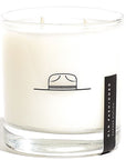 White glass candle with hat etched onto side and black label on right side reading "Old Fashioned"