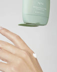 green lotion bottle at the top putting lotion on hand