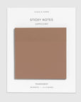 A pack of sticky notes on a white backing card, labeled 'STICKY NOTES CAPPUCCINO' and 'TRANSPARENT 50 SHEETS — 3 x 3 INCHES.' The notes themselves are a muted warm taupe-brown and are shown centered on a light gray background.