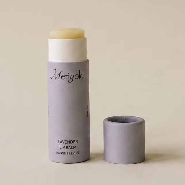open lavender merigold lip balm on a beige background