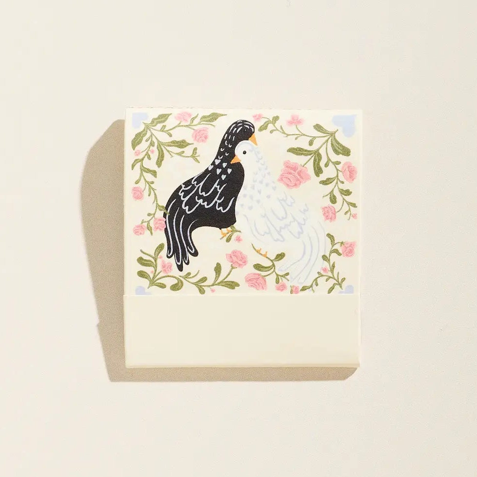 Card with two chickens in a floral wreath on a beige background