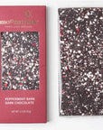 Peppermint Bark Dark Chocolate" bar from Moonstruck, with a maroon packaging design. The bar itself has a speckled look with pieces of white and red peppermint on dark chocolate