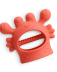 Red silicone teething ring on a white background