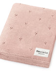 Pink knitted blanket with a 'Bleu La La Organics' label on a white background