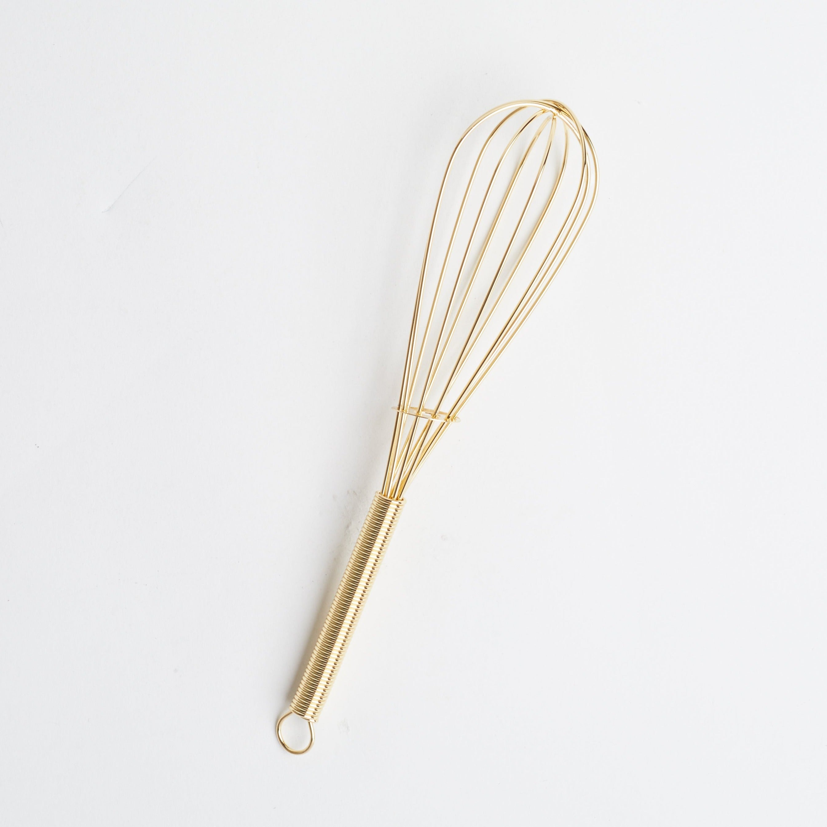 An 8&quot; gold metal whisk against a white background