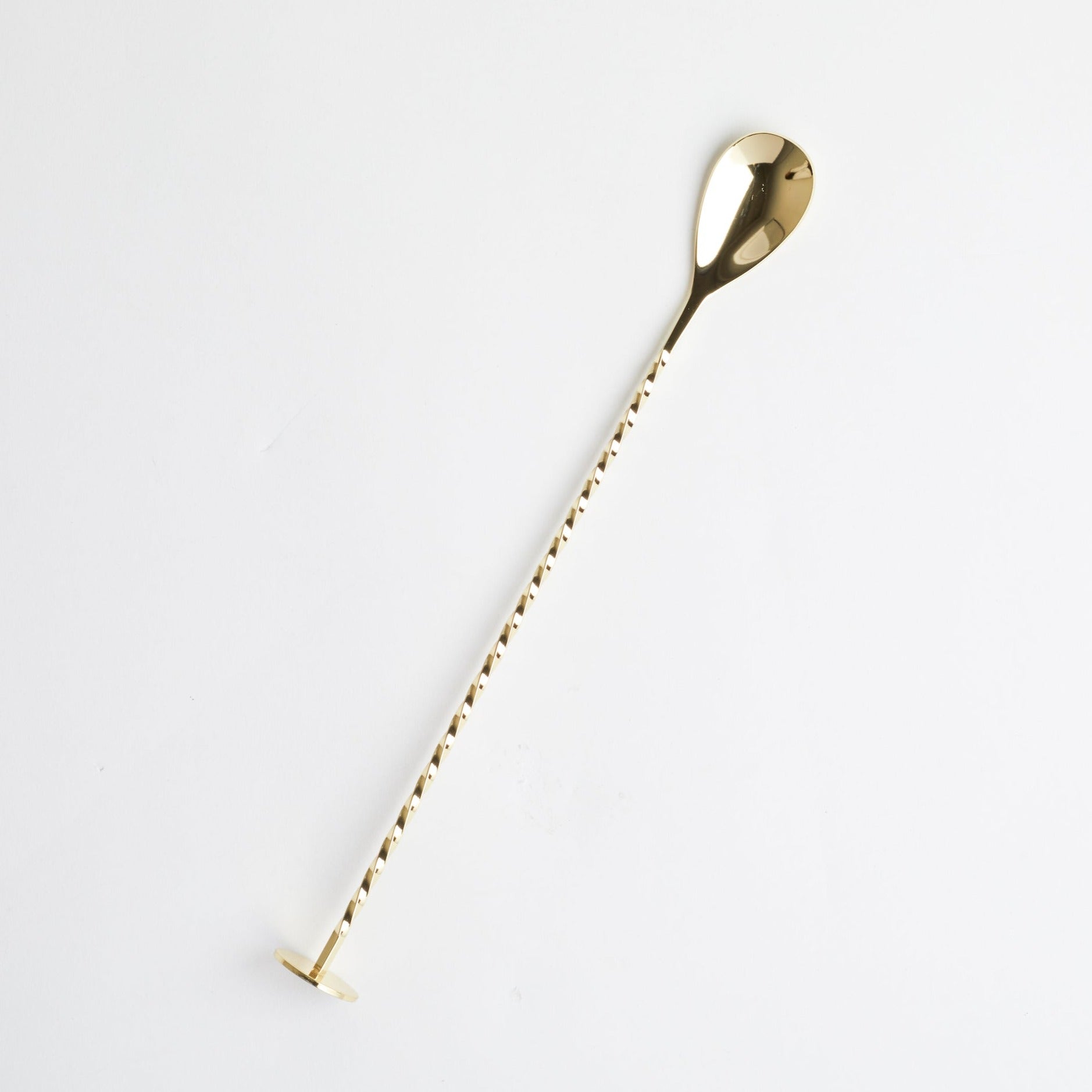 Gold Cocktail Spoon + Muddler on white background