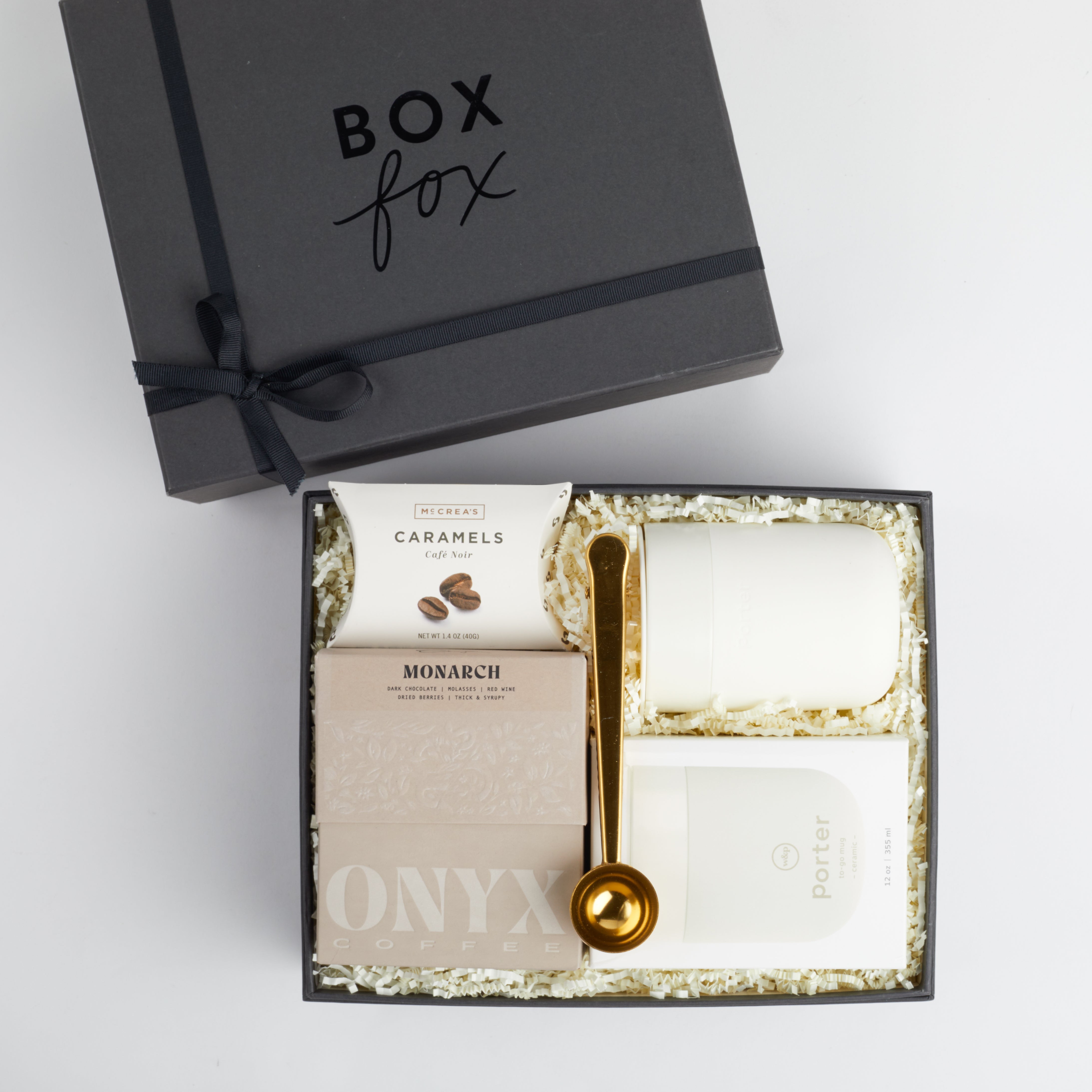 Gold coffee scoop, coffee caramels, cream mug and box of coffee packed in BOXFOX