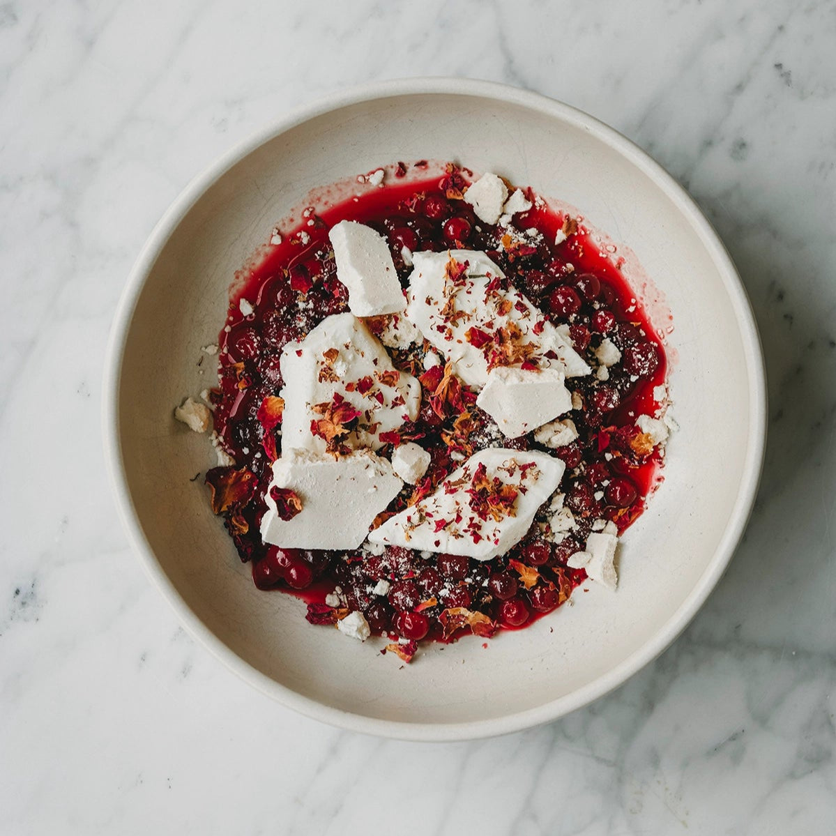 dish with berries and cheese on top