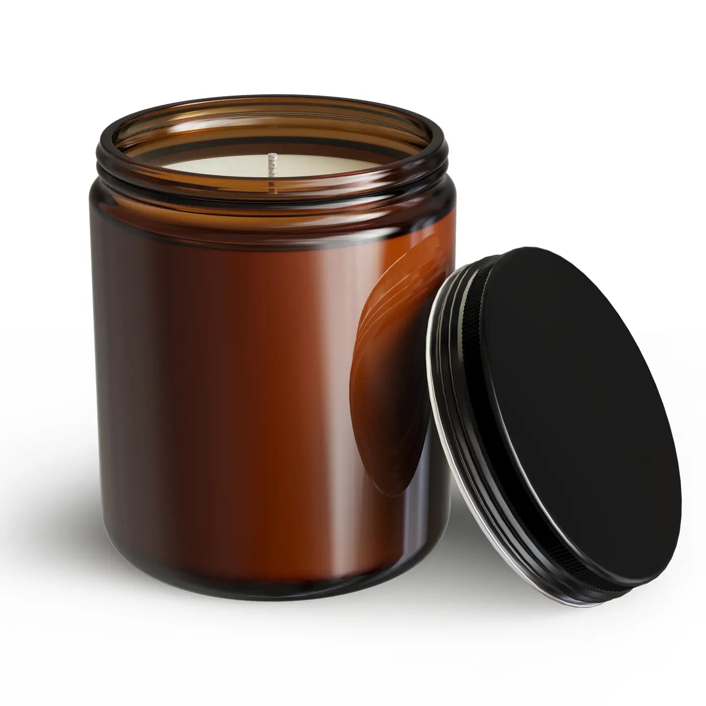 Brown glass candle jar with a black lid on a white background