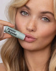 woman holding the poppy & pout lip balm