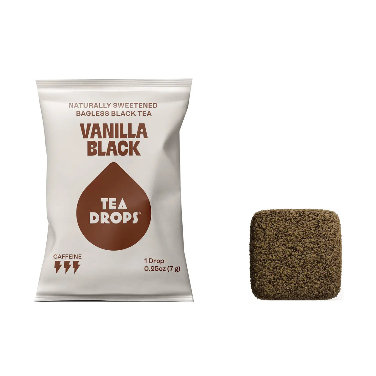 A white bag of Tea Drops Vanilla Black naturally sweetened bagless black tea next to a single square-shaped brown tea drop on a plain white background.