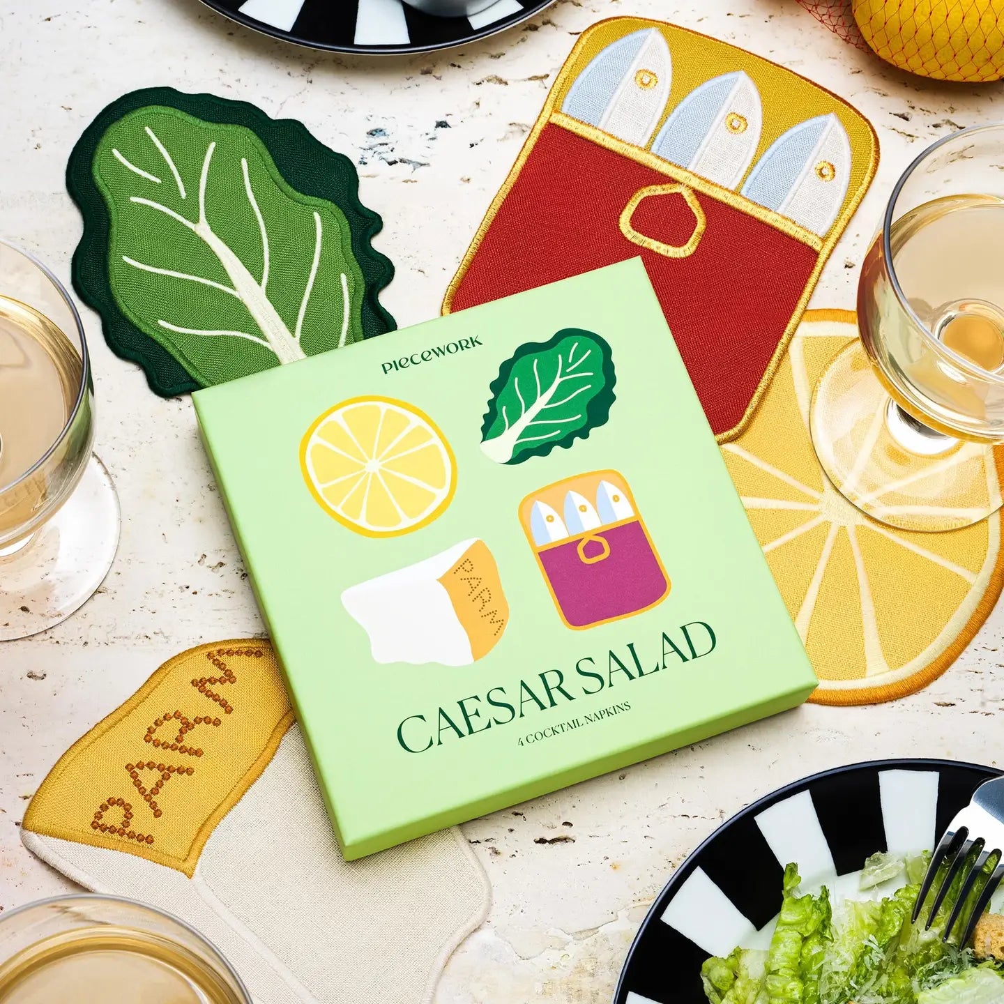 Cookbook titled 'Caesar Salad' with related items on a table