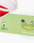 open golf baby book next to red visor