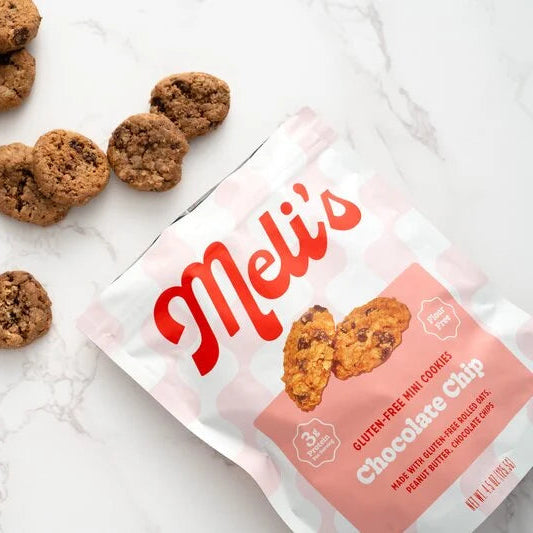Meli's chocolate chip cookies on a marble surface with a pink packaging.