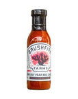Bottle of Brushfire Farms Prickly Pear BBQ Sauce on a white background