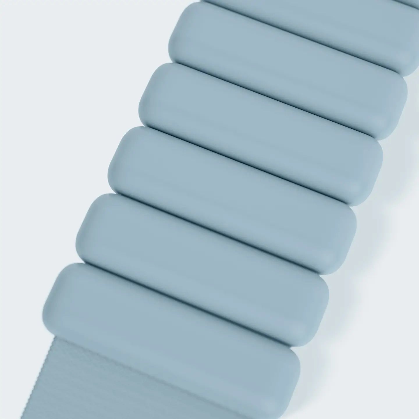 A close-up of a light blue silicone watch strap with a textured woven backing, shown against a clean white background.