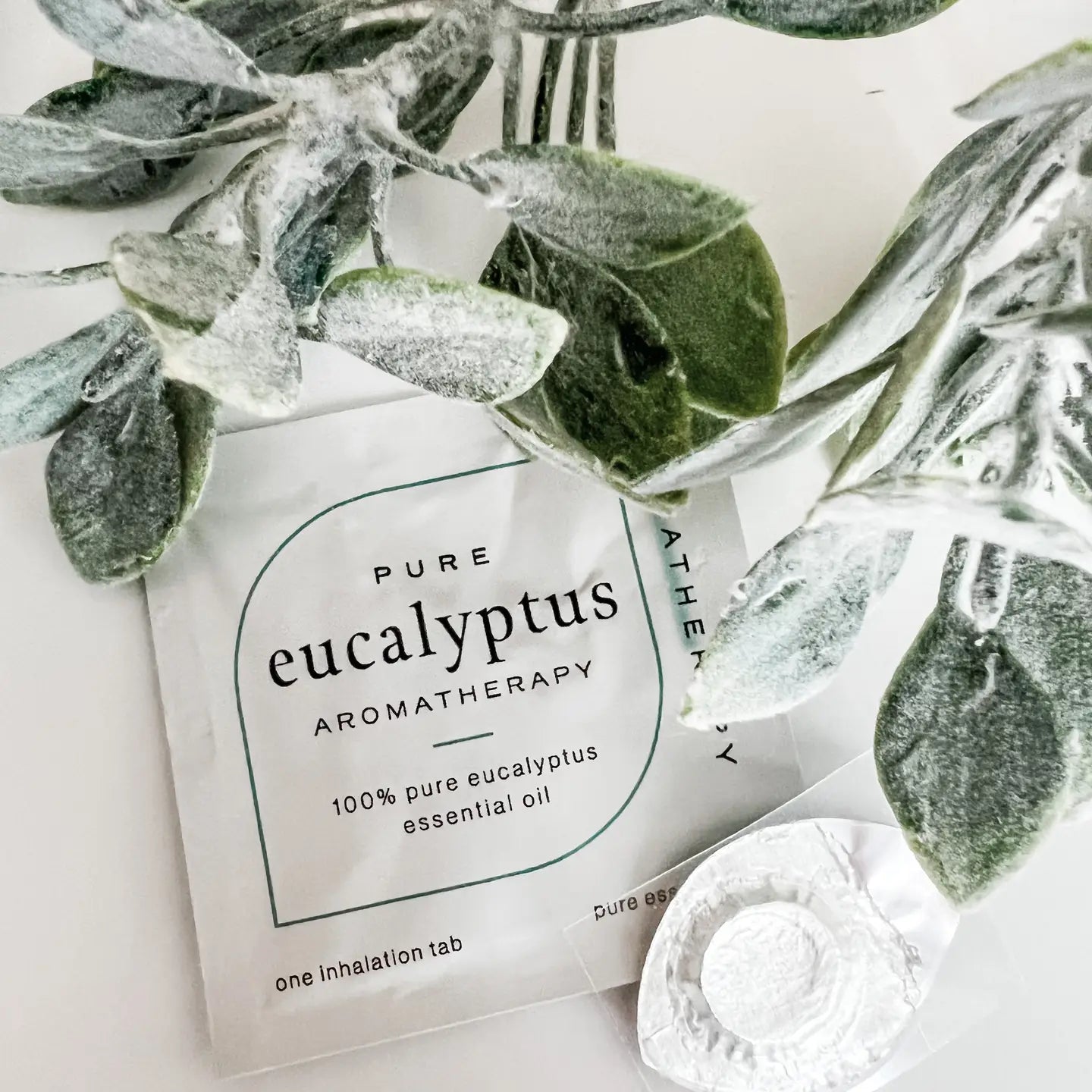 Eucalyptus aromatherapy product with leaves on a light background