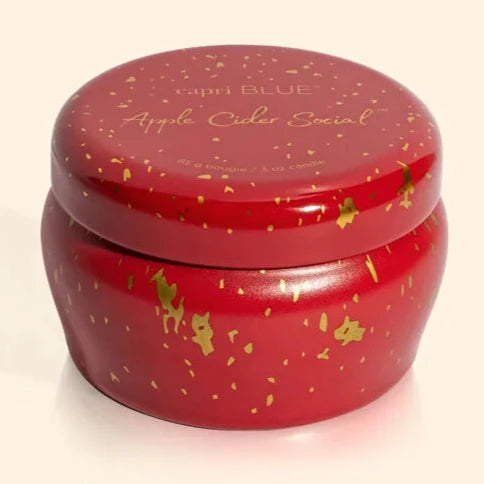 red tin candle with gold sparkles on it