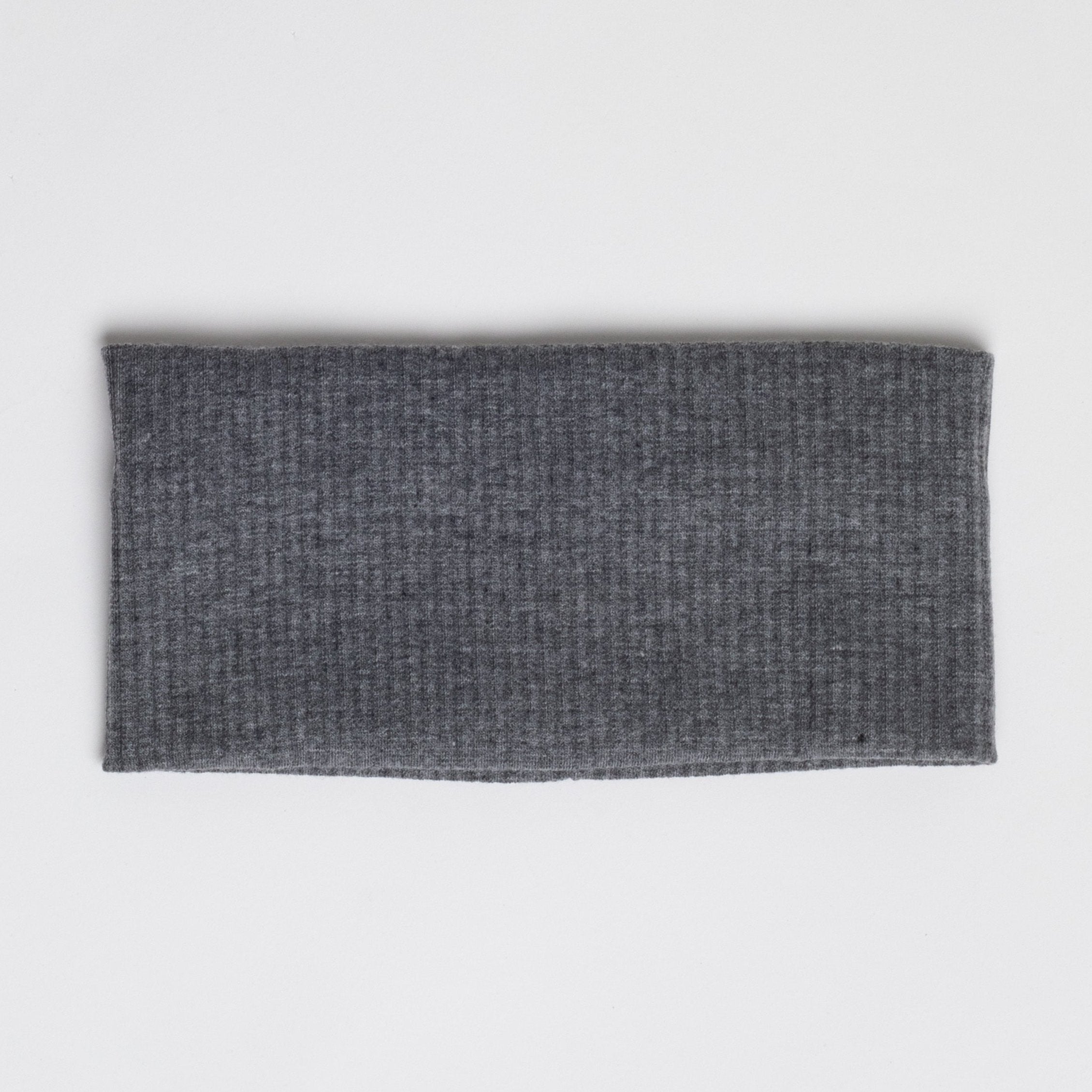 This is an image of a dark gray fabric headband or neck warmer, laid flat on a plain white background.






