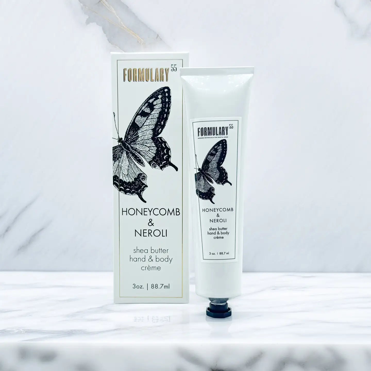 Shea butter hand and body crème with packaging featuring a butterfly design on a white background