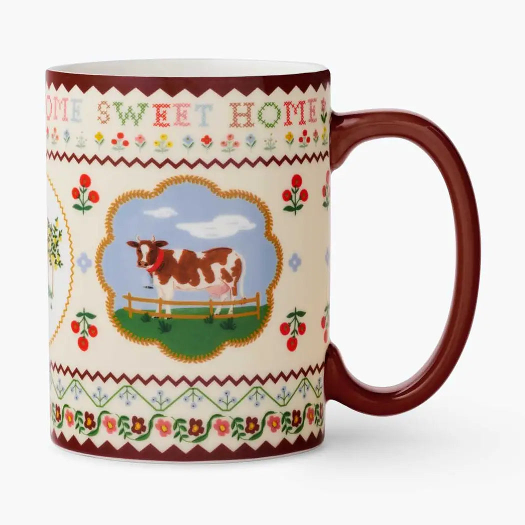 Mug with cow illustration and 'Home Sweet Home' text on a white background