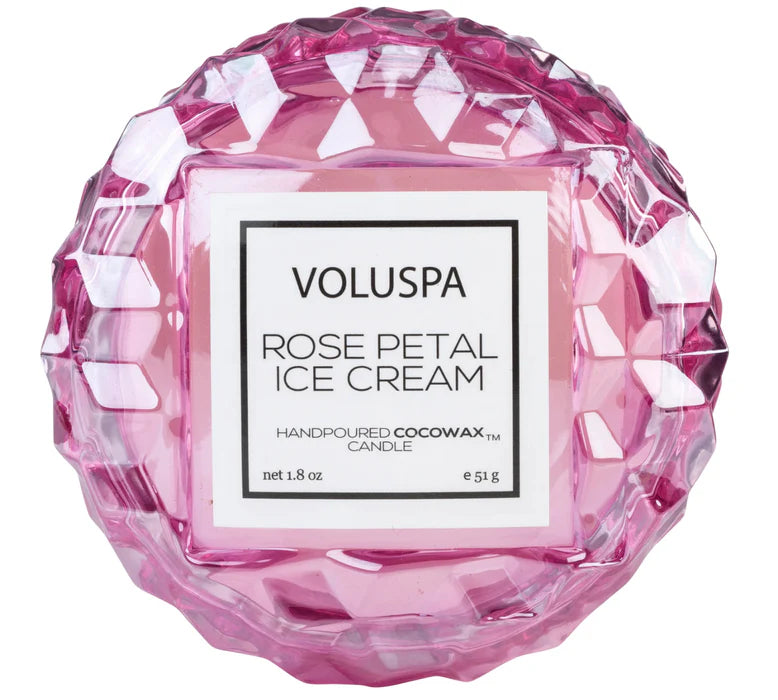 Pink Voluspa candle with a geometric design on a white background