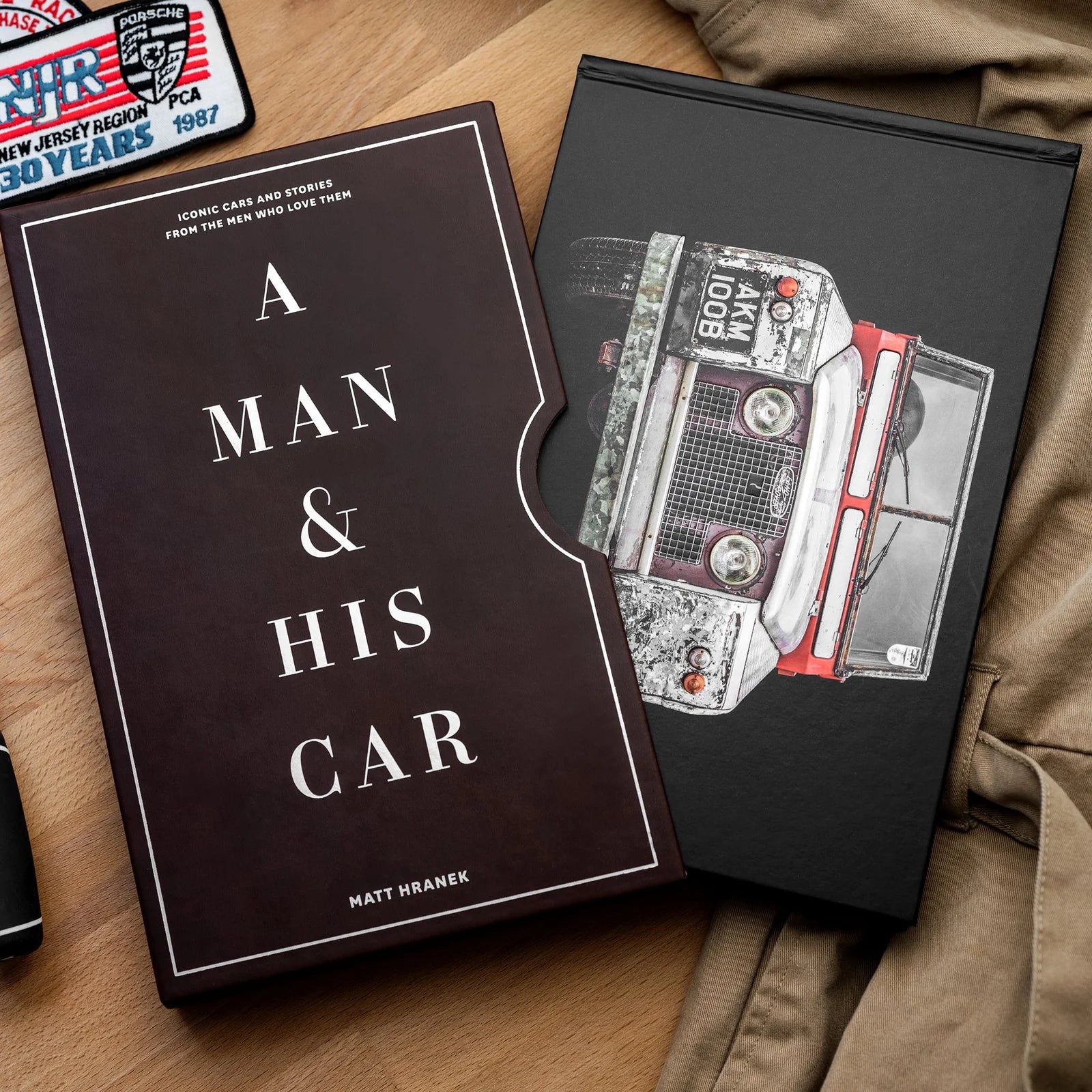 A man and his car book on a brown table