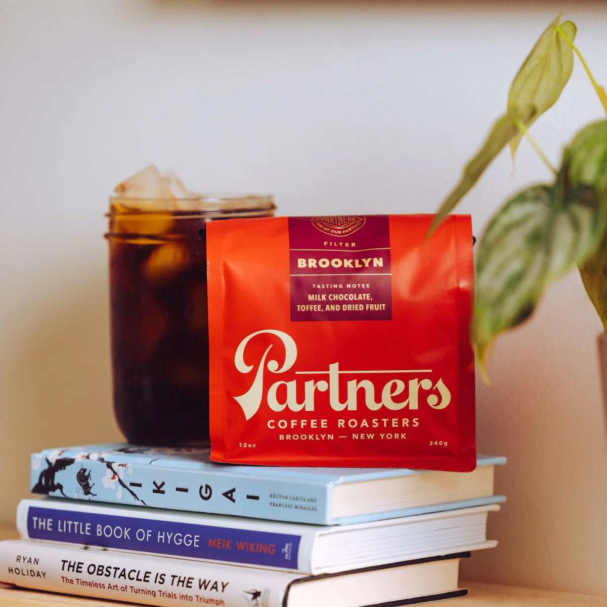 red coffee bag with maroon sticker and 'Partners' written on it in white