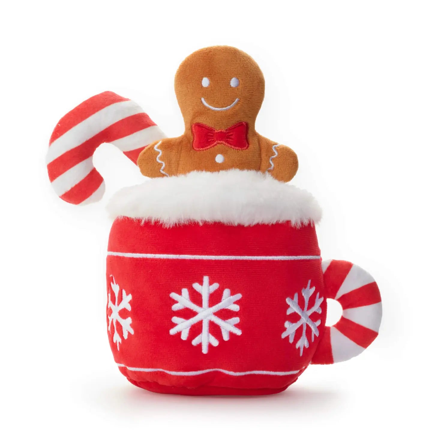 Plush toy resembling a gingerbread man in a red mug with snowflake patterns, holding a candy cane on a white background.