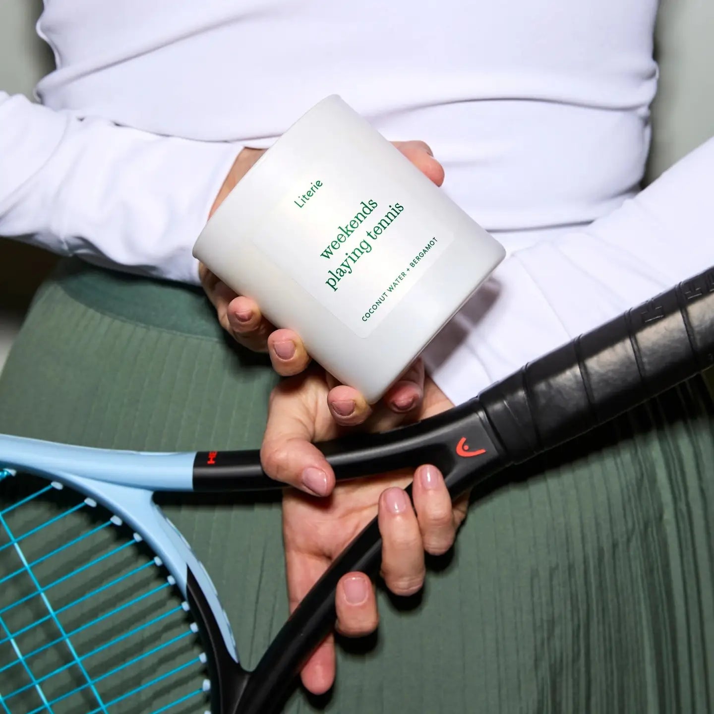 someone holding the weekends playing tennis candle