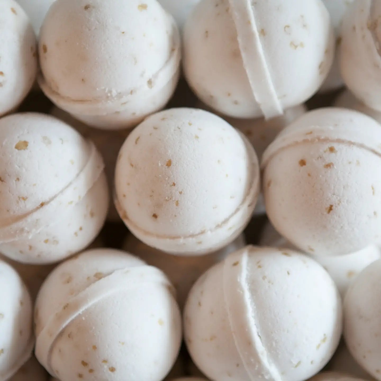 Close-up of beige bath bombs with a white background