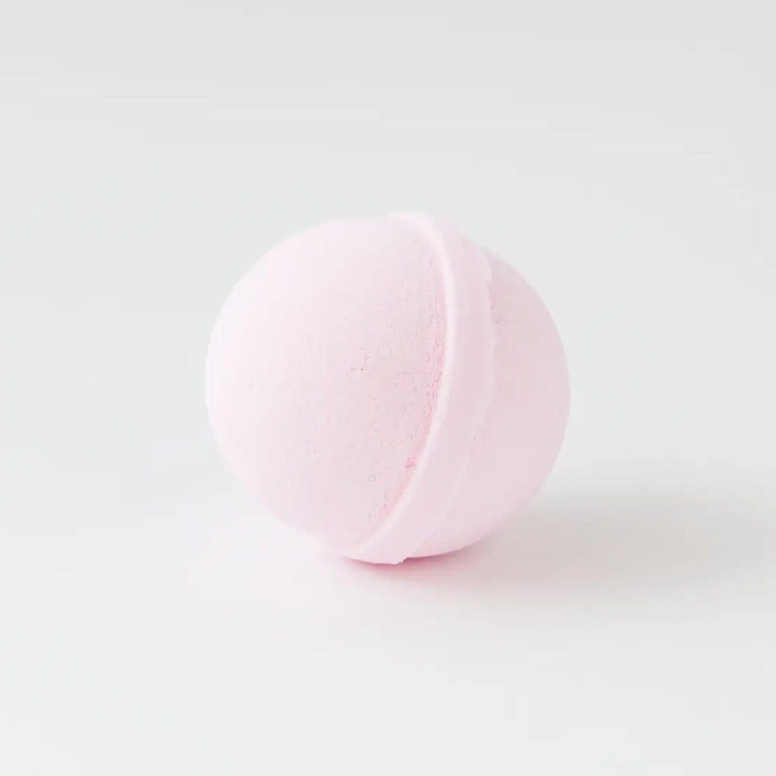Pink bath bomb on a light gray background