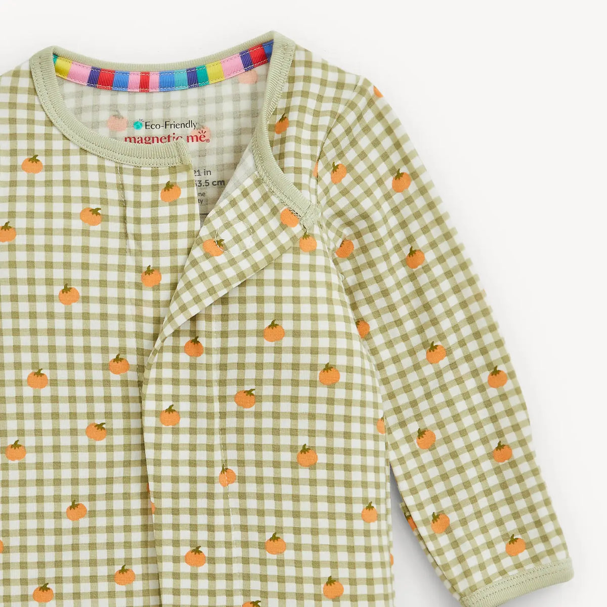 Green checkered baby outfit with orange pumpkin patterns on a white background