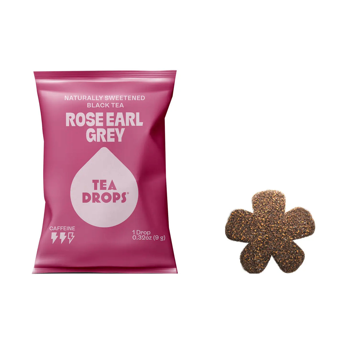 A pink bag of Rose Earl Grey Tea Drops next to a single flower-shaped tea drop on a plain white background.