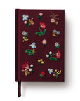 Maroon notebook with floral embroidery on a white background