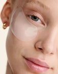 Close-up of a person's face with a patch over one eye against a neutral background
