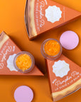 Pumpkin Pie lip scrub and lip balm set on an orange background
